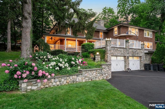 193 S Franklin Tpke, Ramsey, NJ 07446 - view of front of property with asphalt driveway, stone siding, an attached garage, and a chimney