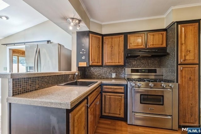 277 Jefferson Ave, Cresskill, NJ 07626 - kitchen with appliances with stainless steel finishes, exhaust hood, a sink, brown cabinetry, and dark wood finished floors