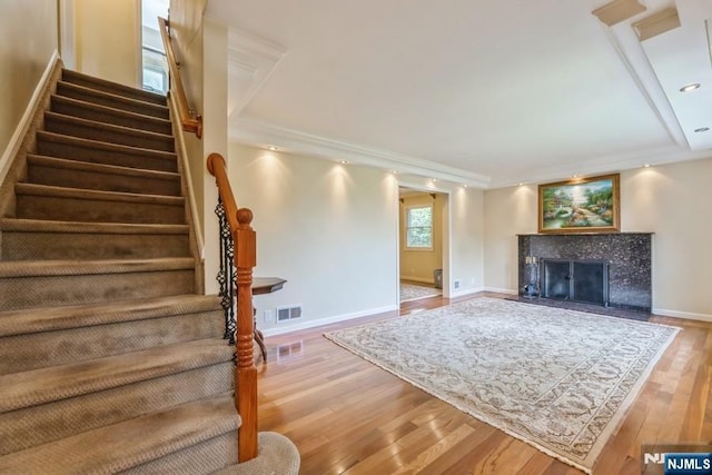 277 Jefferson Ave, Cresskill, NJ 07626 - living area with stairway, baseboards, wood finished floors, a fireplace with flush hearth, and ornamental molding