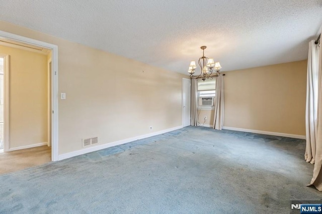 277 Jefferson Ave, Cresskill, NJ 07626 - empty room with a chandelier, carpet flooring, cooling unit, baseboards, and a textured ceiling