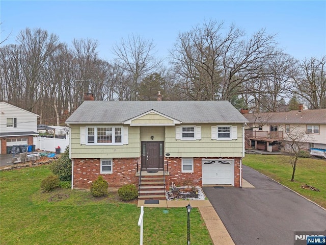 70 Highland Rd, North Haledon, NJ 07508 - bi-level home featuring brick siding, driveway, a chimney, a garage, and a front lawn