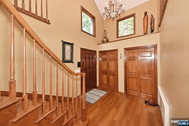 24 Old Chimney Rd, Upper Saddle River, NJ 07458 - foyer entrance featuring high vaulted ceiling, stairs, wood finished floors, and a chandelier