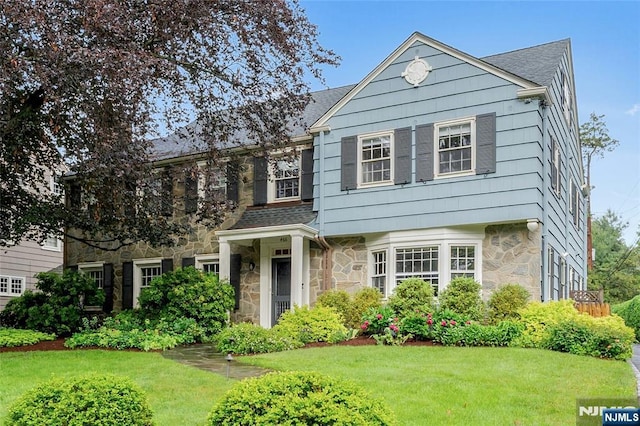 466 Park St, Montclair, NJ 07043 - view of front of home featuring stone siding, a front yard, and a shingled roof