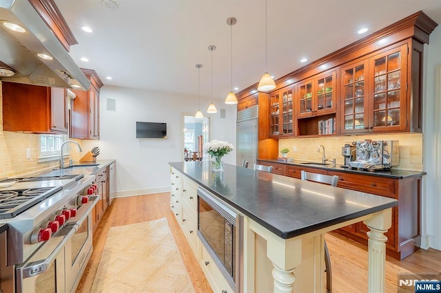 466 Park St, Montclair, NJ 07043 - kitchen with built in appliances, a sink, range hood, dark countertops, and recessed lighting