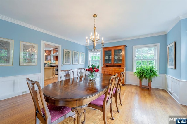 466 Park St, Montclair, NJ 07043 - dining area featuring a chandelier, wainscoting, ornamental molding, a decorative wall, and light wood-style flooring