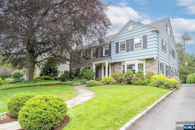 466 Park St, Montclair, NJ 07043 - view of front of property featuring stone siding, a front lawn, and a chimney