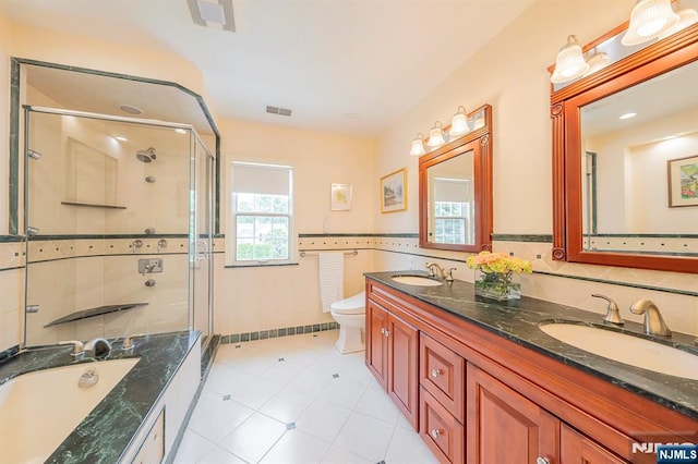 466 Park St, Montclair, NJ 07043 - bathroom featuring double vanity, a stall shower, toilet, a garden tub, and tile patterned flooring