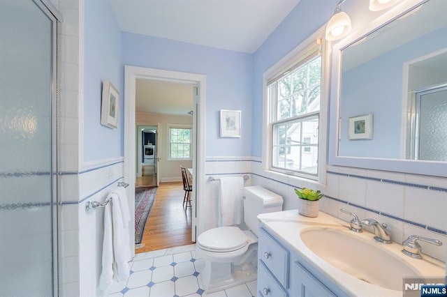 466 Park St, Montclair, NJ 07043 - full bathroom featuring tile walls, toilet, vanity, a shower with shower door, and tile patterned floors