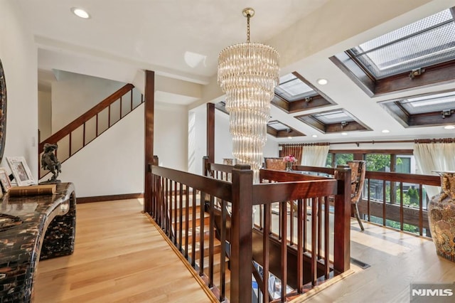 1060 Briar Way, Fort Lee, NJ 07024 - stairway with wood finished floors, a chandelier, a skylight, recessed lighting, and ornamental molding
