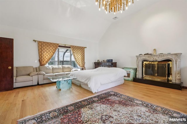 1060 Briar Way, Fort Lee, NJ 07024 - bedroom featuring lofted ceiling, wood finished floors, a chandelier, and a fireplace