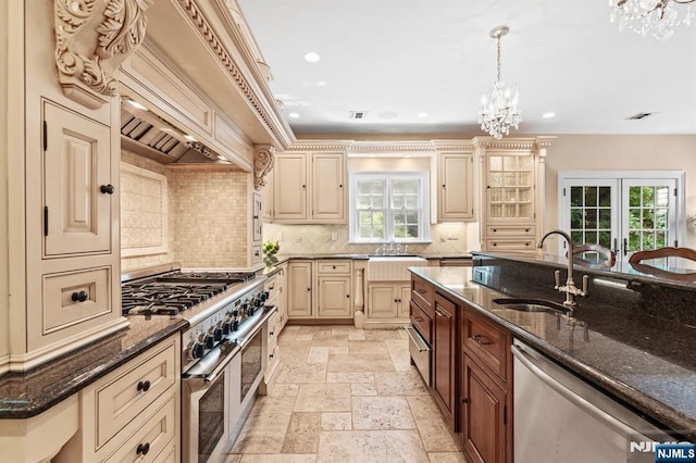 56 Knoll Rd, Tenafly, NJ 07670 - kitchen with stainless steel appliances, a chandelier, a sink, cream cabinetry, and recessed lighting