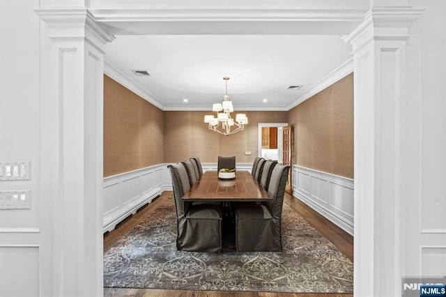 56 Knoll Rd, Tenafly, NJ 07670 - dining area with dark wood-style flooring, a chandelier, ornate columns, wainscoting, and ornamental molding