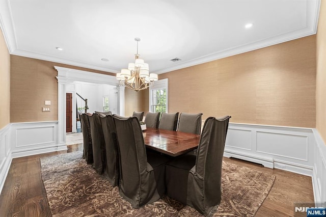 56 Knoll Rd, Tenafly, NJ 07670 - dining space with a chandelier, ornamental molding, wainscoting, dark wood-style flooring, and a decorative wall