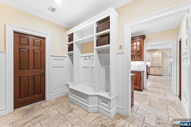 56 Knoll Rd, Tenafly, NJ 07670 - mudroom with stone tile flooring, ornamental molding, a wainscoted wall, and a decorative wall