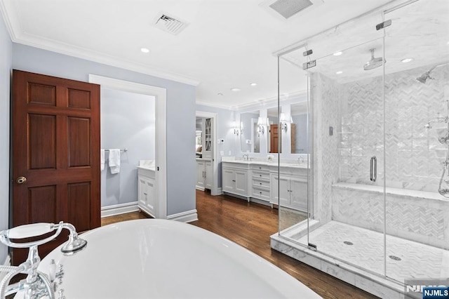 56 Knoll Rd, Tenafly, NJ 07670 - bathroom featuring vanity, wood finished floors, a soaking tub, a stall shower, and ornamental molding