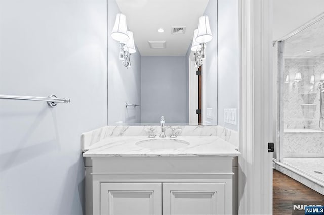 56 Knoll Rd, Tenafly, NJ 07670 - bathroom with a shower stall, vanity, recessed lighting, and wood finished floors