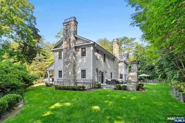 56 Knoll Rd, Tenafly, NJ 07670 - back of property featuring a chimney, an outdoor hangout area, a yard, and a patio