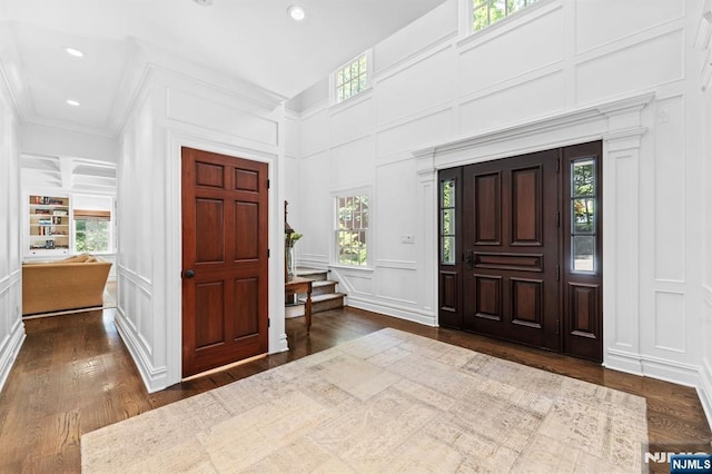 56 Knoll Rd, Tenafly, NJ 07670 - entryway with a decorative wall, dark wood-style flooring, healthy amount of natural light, crown molding, and recessed lighting