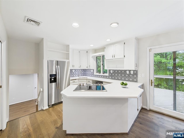 995 Andover Ter, Ridgewood, NJ 07450 - kitchen featuring stainless steel fridge with ice dispenser, open shelves, a peninsula, white cabinets, and decorative backsplash