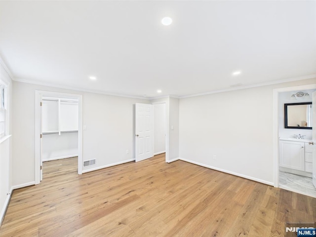 995 Andover Ter, Ridgewood, NJ 07450 - basement with crown molding, recessed lighting, light wood finished floors, baseboards, and a sink