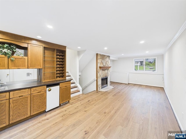 995 Andover Ter, Ridgewood, NJ 07450 - kitchen featuring open shelves, light wood finished floors, dark countertops, ornamental molding, and brown cabinets