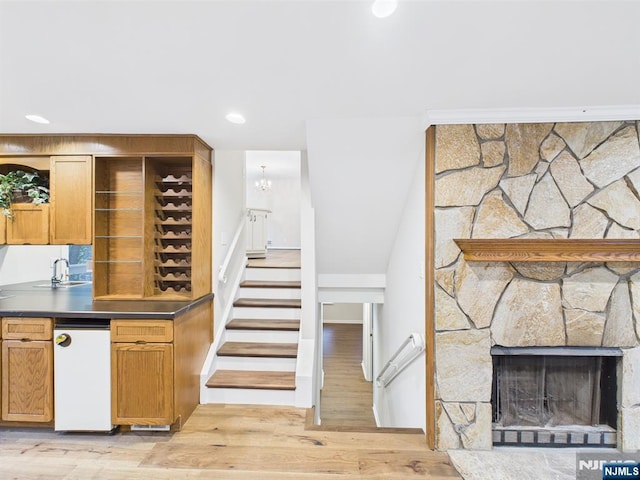 995 Andover Ter, Ridgewood, NJ 07450 - stairway with wood finished floors, a stone fireplace, recessed lighting, and a chandelier