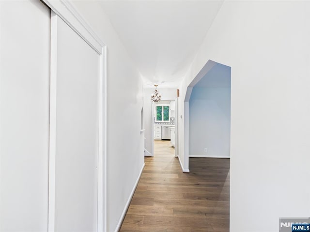 995 Andover Ter, Ridgewood, NJ 07450 - hall with wood finished floors, a chandelier, and baseboards