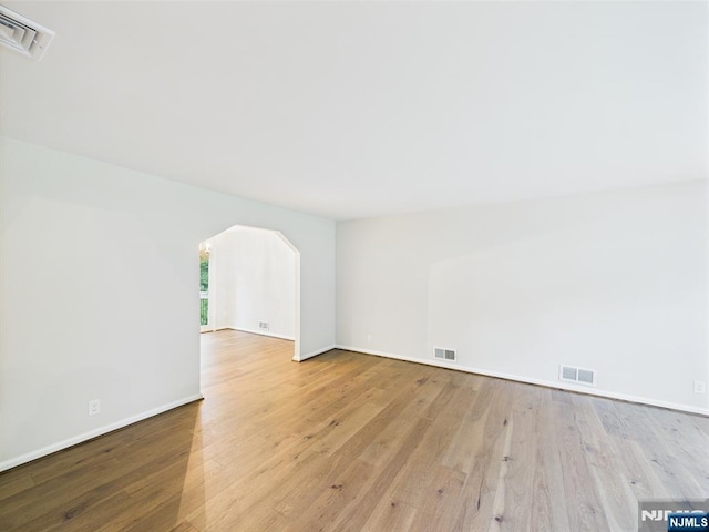 995 Andover Ter, Ridgewood, NJ 07450 - spare room with wood-type flooring, arched walkways, and baseboards