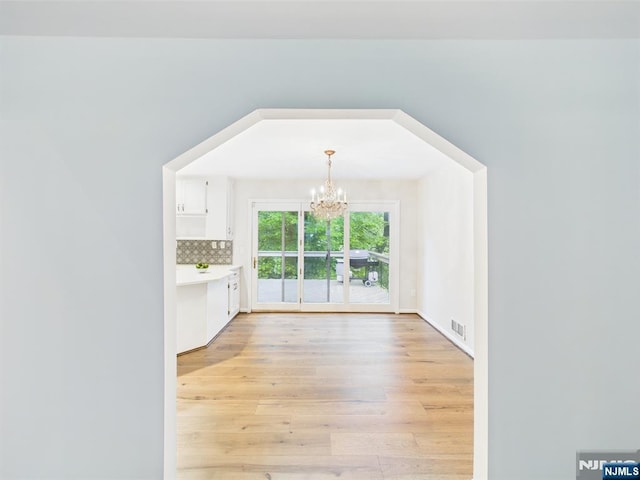 995 Andover Ter, Ridgewood, NJ 07450 - unfurnished dining area featuring a chandelier and light wood-style flooring