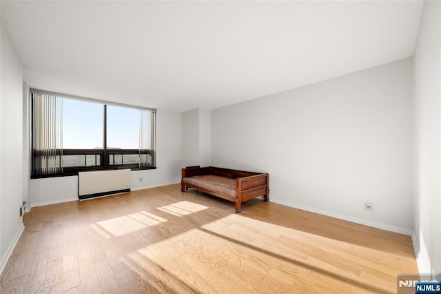 800 Palisade Ave Unit 1804, Fort Lee, NJ 07024 - bedroom featuring radiator, wood finished floors, and baseboards