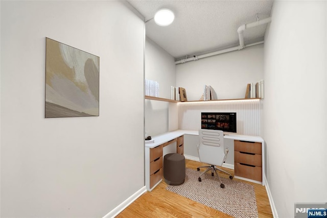 800 Palisade Ave Unit 1804, Fort Lee, NJ 07024 - office area featuring light wood-style floors, baseboards, and a textured ceiling