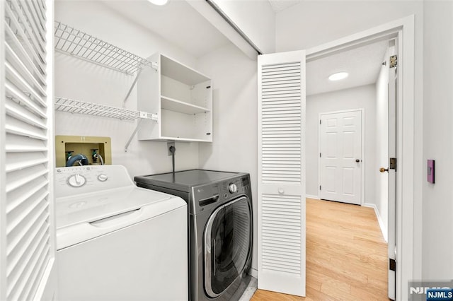 800 Palisade Ave Unit 1804, Fort Lee, NJ 07024 - washroom featuring washing machine and dryer, light wood-style floors, and baseboards