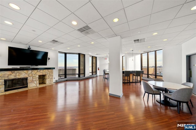 800 Palisade Ave Unit 1804, Fort Lee, NJ 07024 - living area featuring a wall of windows, plenty of natural light, wood finished floors, and a stone fireplace