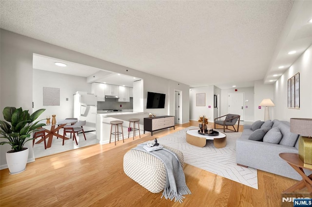 800 Palisade Ave Unit 1804, Fort Lee, NJ 07024 - living area featuring light wood finished floors, a textured ceiling, and recessed lighting