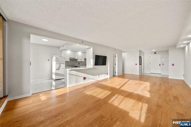 800 Palisade Ave Unit 1804, Fort Lee, NJ 07024 - unfurnished living room with a textured ceiling, light wood finished floors, baseboards, and recessed lighting