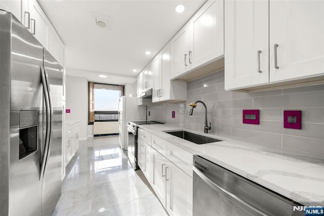 800 Palisade Ave Unit 1804, Fort Lee, NJ 07024 - kitchen featuring appliances with stainless steel finishes, a sink, tasteful backsplash, white cabinets, and recessed lighting