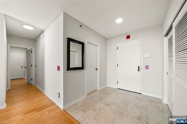 800 Palisade Ave Unit 1804, Fort Lee, NJ 07024 - hall with a textured ceiling and baseboards