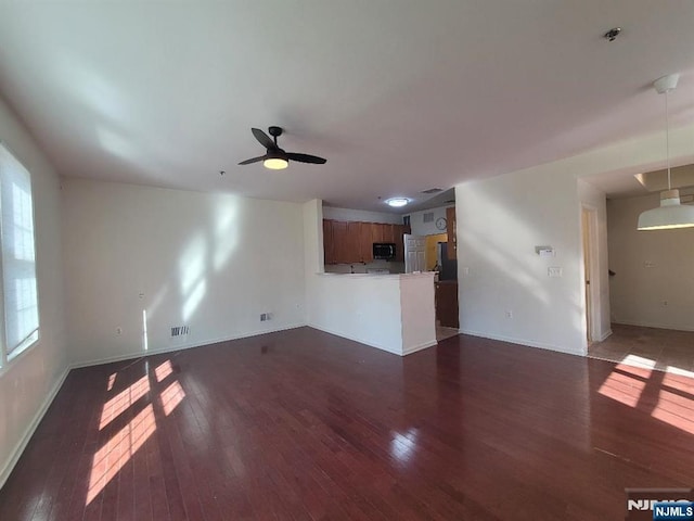 45 Birch St Unit 207, Ridgefield Park, NJ 07660 - unfurnished living room featuring dark wood-style floors, a ceiling fan, and baseboards