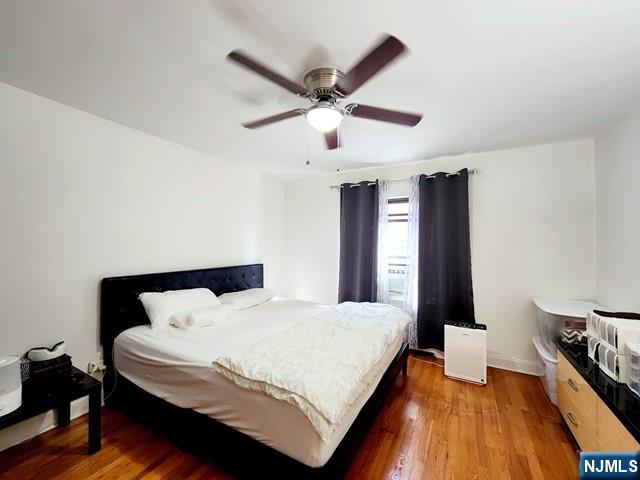 2163B N Central Rd Unit B, Fort Lee, NJ 07024 - bedroom featuring wood finished floors, baseboards, and a ceiling fan