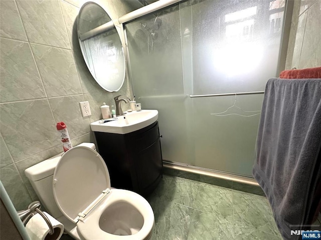 3041 Edwin Unit 4E, Fort Lee, NJ 07024 - bathroom featuring tile walls, a shower stall, vanity, and toilet