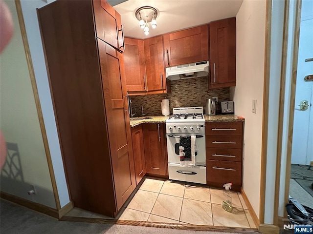 3041 Edwin Unit 4E, Fort Lee, NJ 07024 - kitchen featuring exhaust hood, white gas range, backsplash, light tile patterned floors, and light stone counters