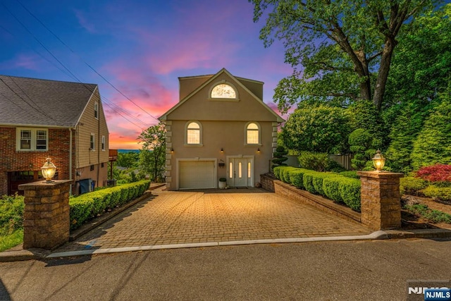 801 Oakwood Ln, Ridgefield, NJ 07657 - view of front of house featuring a garage, driveway, and stucco siding