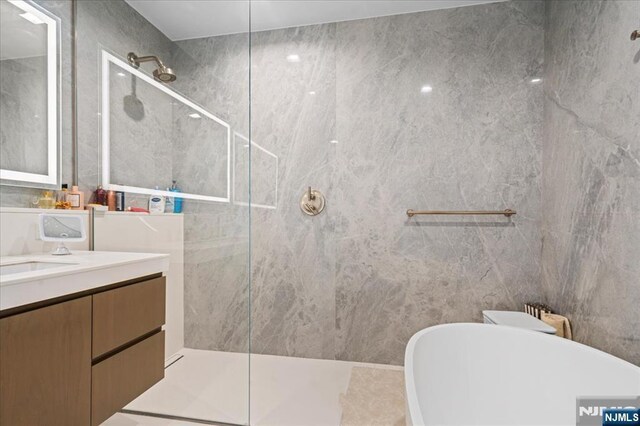 320 Adolphus Ave Unit 317, Cliffside Park, NJ 07010 - bathroom featuring a walk in shower, vanity, and a soaking tub
