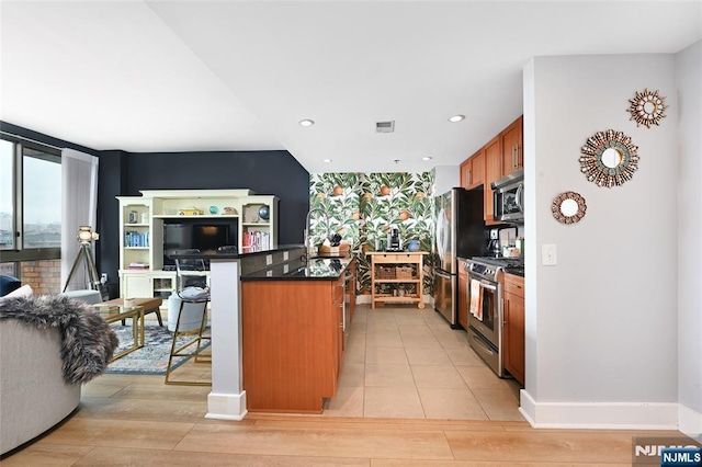 800 Jackson St Unit 505, Hoboken, NJ 07030 - kitchen with appliances with stainless steel finishes, dark countertops, brown cabinets, a kitchen breakfast bar, and open floor plan