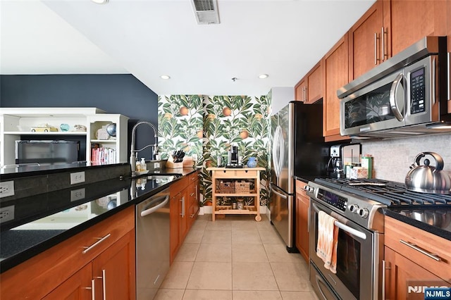 800 Jackson St Unit 505, Hoboken, NJ 07030 - kitchen featuring stainless steel appliances, a sink, decorative backsplash, brown cabinets, and light tile patterned floors