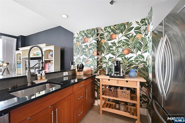 800 Jackson St Unit 505, Hoboken, NJ 07030 - kitchen featuring freestanding refrigerator, a sink, dark stone counters, brown cabinetry, and light tile patterned floors