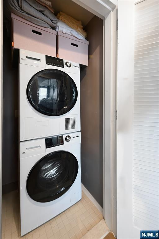 800 Jackson St Unit 505, Hoboken, NJ 07030 - laundry area featuring stacked washer / dryer and baseboards