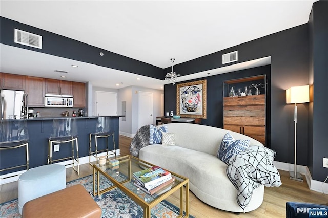 800 Jackson St Unit 505, Hoboken, NJ 07030 - living area featuring light wood finished floors, baseboards, a chandelier, and recessed lighting