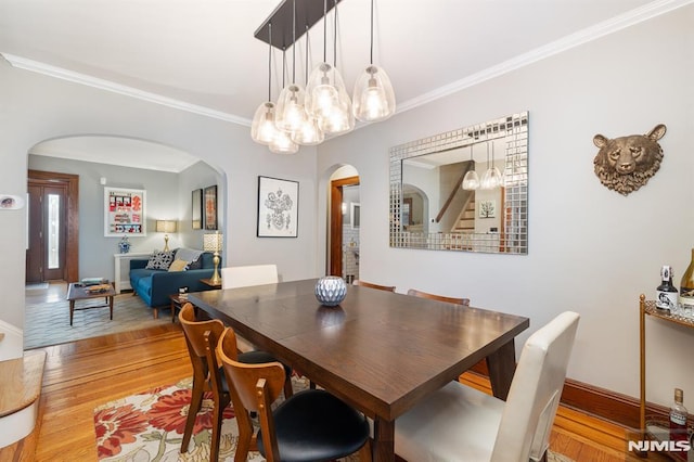 206 Eastern Way, Rutherford, NJ 07070 - dining area featuring arched walkways, wood finished floors, crown molding, and a chandelier