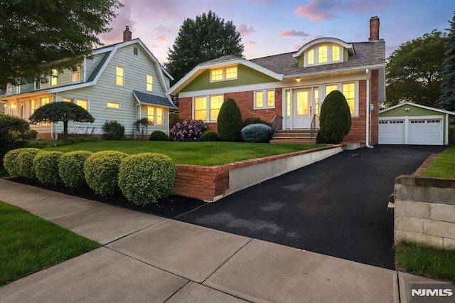 206 Eastern Way, Rutherford, NJ 07070 - view of front of property featuring an outdoor structure, a garage, brick siding, a chimney, and a lawn